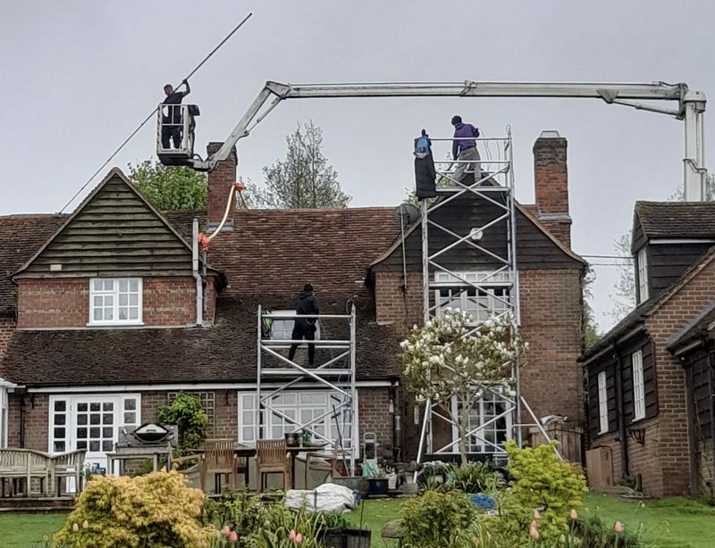 The Roof Moss Cleaners using cherry picker and scaffolding to clean roof safely and professionally in Sonning Common, Oxfordshire